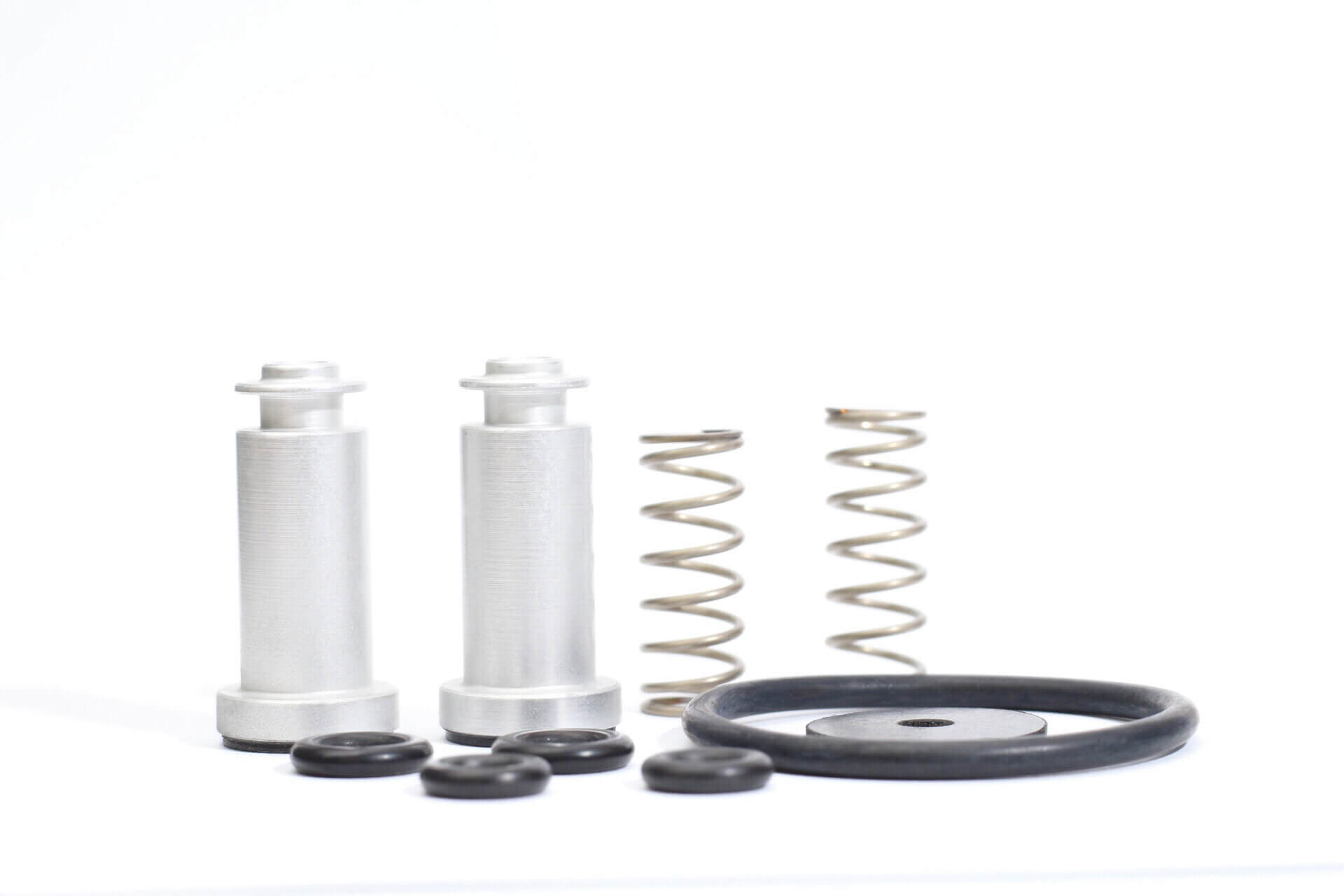 Machined air brake valve pistons with springs, O-rings and a rubber diaphragm from a ManuMark repair kit